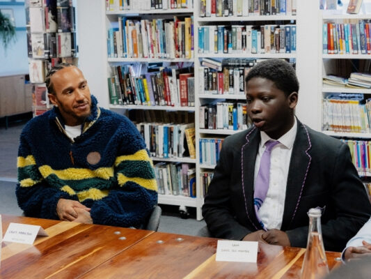 Sir Lewis Hamilton and a student at Oasis Academy South Bank attending the roundtable